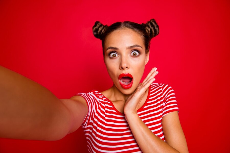 surprised girl on a red background